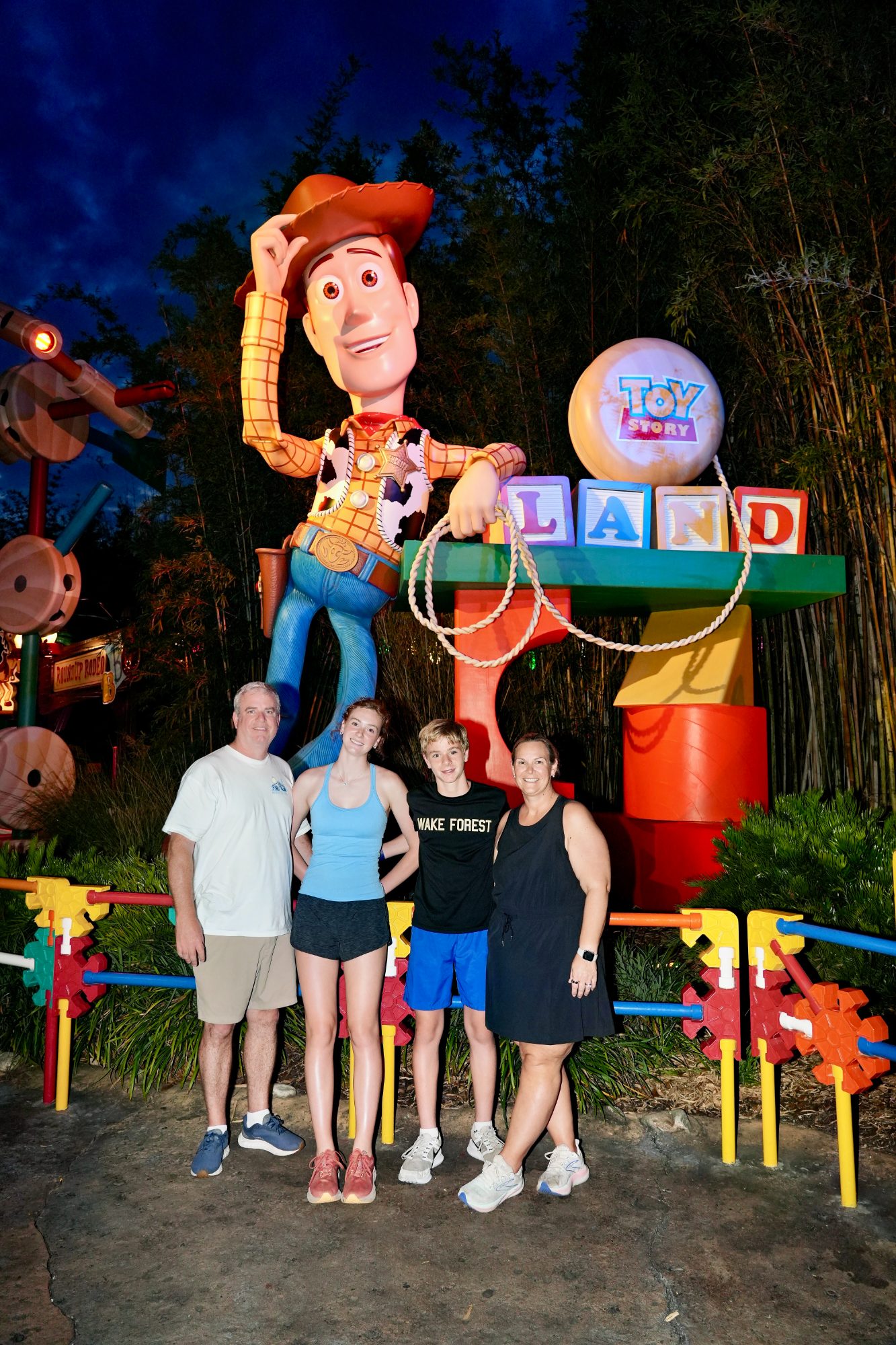 The family at Toy Story Land after dark