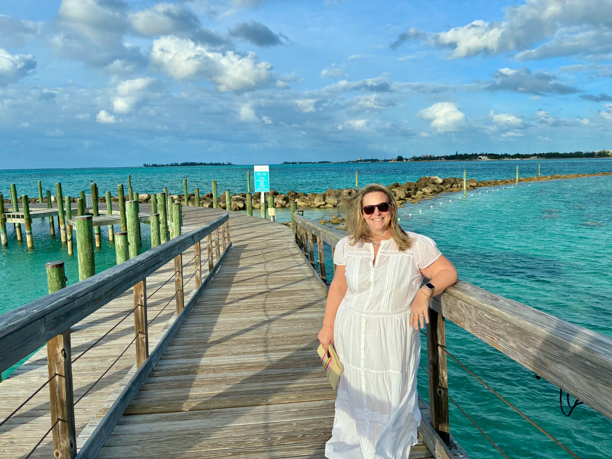 Liz on a dock over turquoise Bahamian water