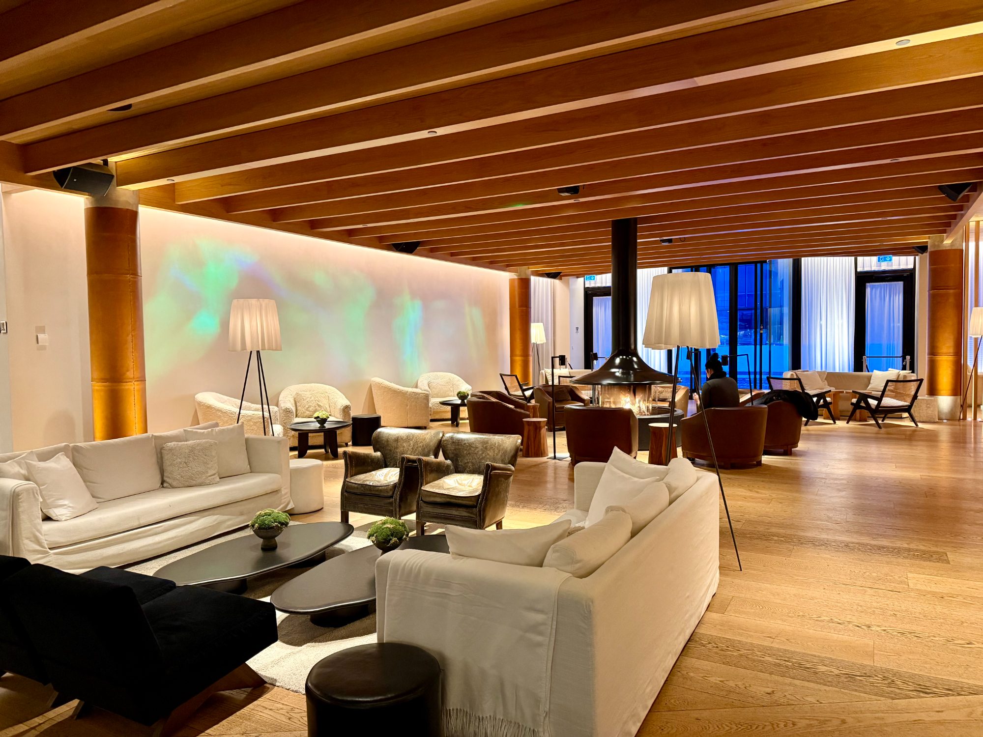 The warm, wood-lined lobby lounge of The Reykjavik EDITION