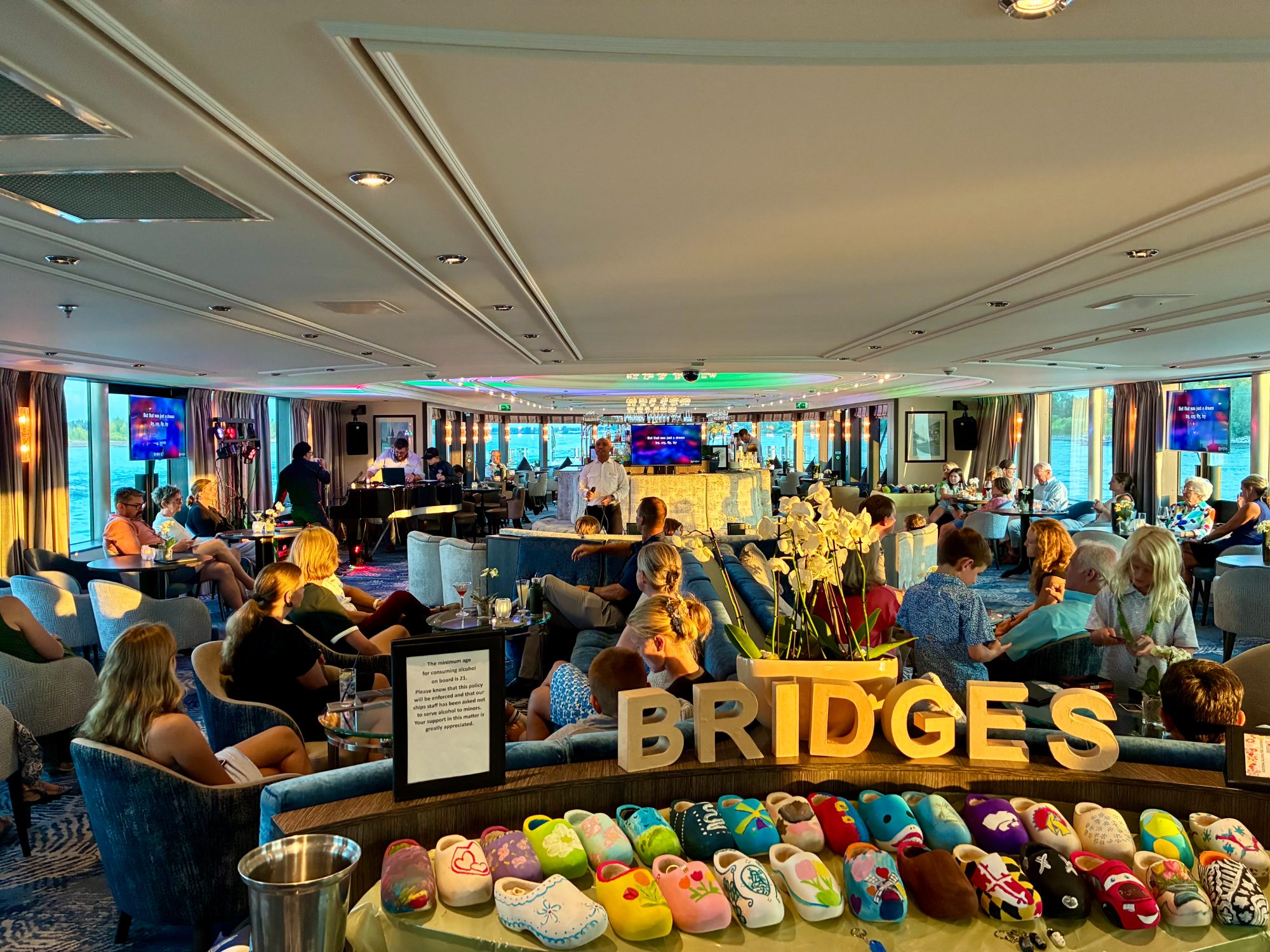 The ship's lounge in the evening, three generations gathered together